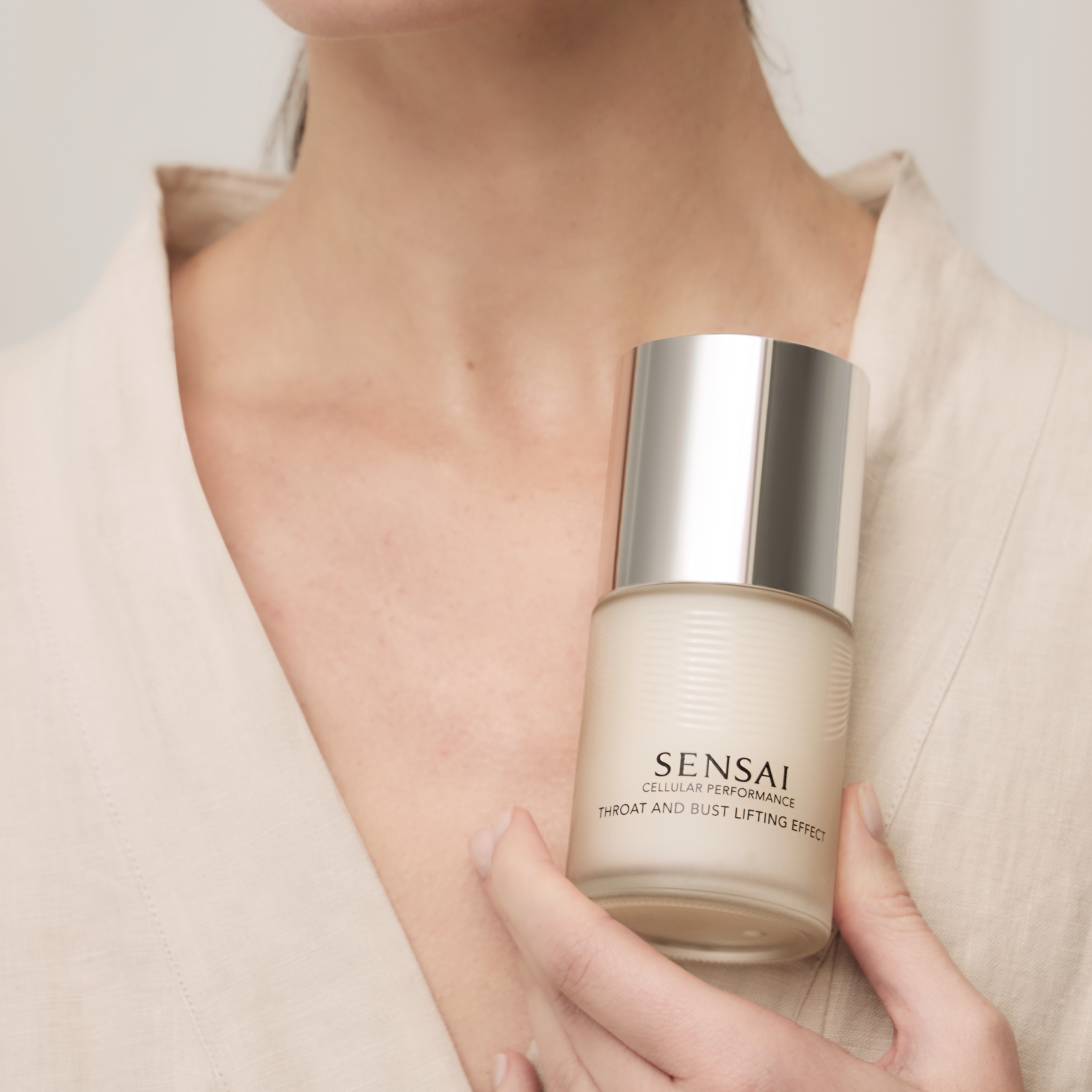 Cellular Performance Throat & Bust Lifting Effect being held in hand and applied on decolette of model